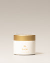Jar of 'The Balm' on a light beige background