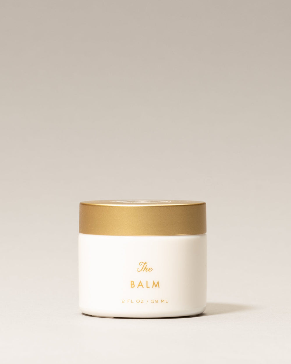 Jar of 'The Balm' on a light beige background