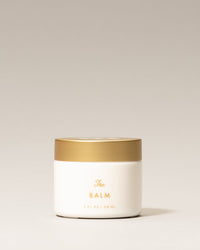 Jar of 'The Balm' on a light beige background